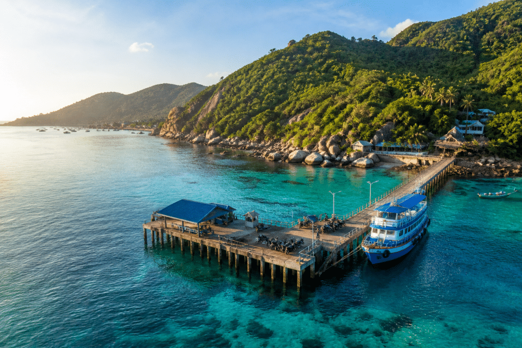 omprayah speedboat departing Mae Haad Pier Koh Tao turquoise Gulf of Thailand waters heading to Chumphon Bangkok, aerial view, photorealistic travel photography 2026